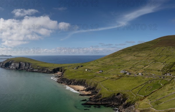 Landscape view of the turquoise waters and golden sand beach at Slea Head on the Dingle Peninsula of County Kerry in western Ireland