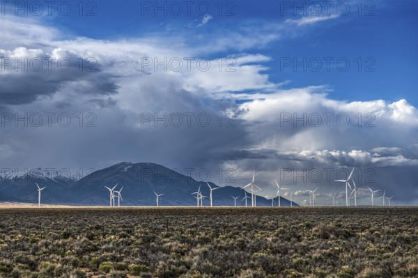 Wind turbines and wild thunder and rain clouds over the Great Basin Highway US 93, between Ely and Baker, Nevada, USA, North America