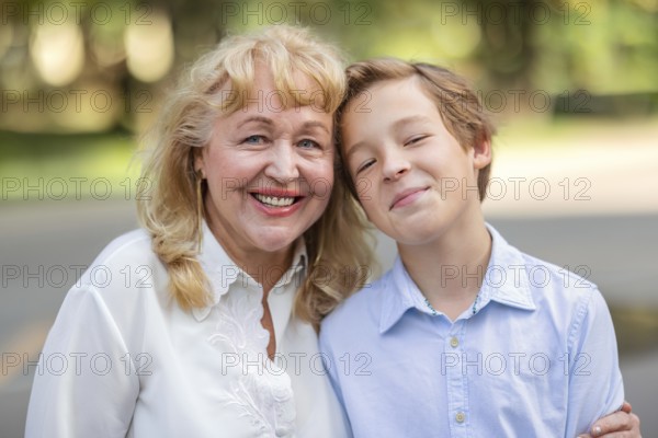 Teenager boy is happy to spend time with grandma. Family portrait is full of happiness and warmth