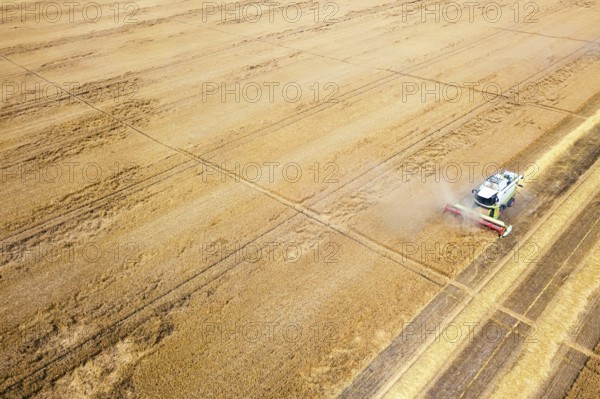 Combine harvester working on a wheat field. Combine harvester Aerial view