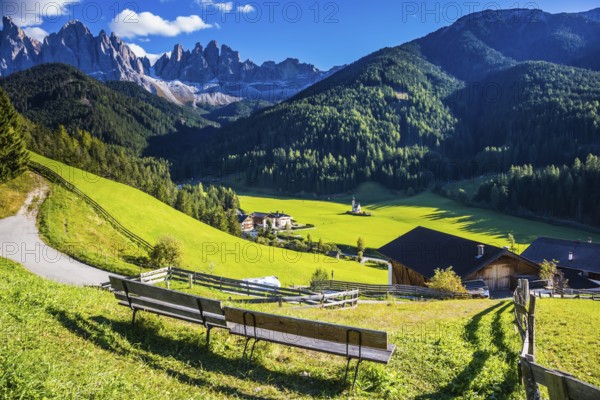 Picturesque Val di Funes. Sunny autumn day in Dolomites, Tirol. Rocky peaks and forested mountains surrounded by green Alpine meadows
