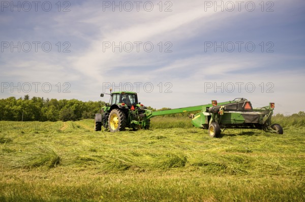 Big American tractor working on a farm with specialised equipement, New York State, USA, North America