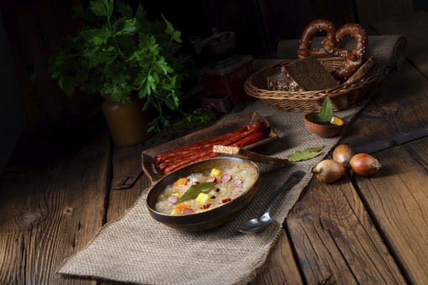 Rustic sauerkraut soup with bacon and sausage