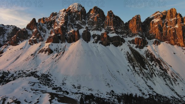 Aerial view of amazing rocky mountains in snow at sunrise, Dolomites, Italy, Europe