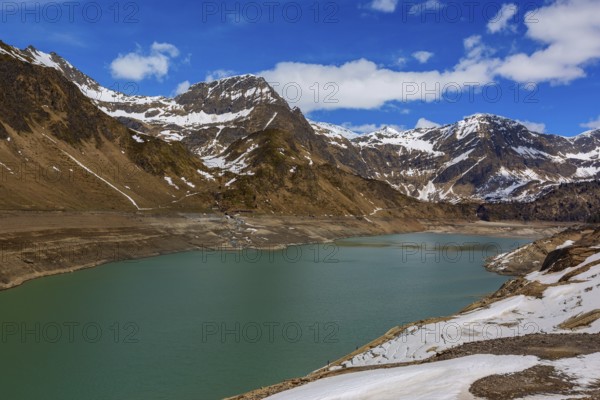 Mountain snow landscape with Lago di Ritom lake at spring in Switzerland