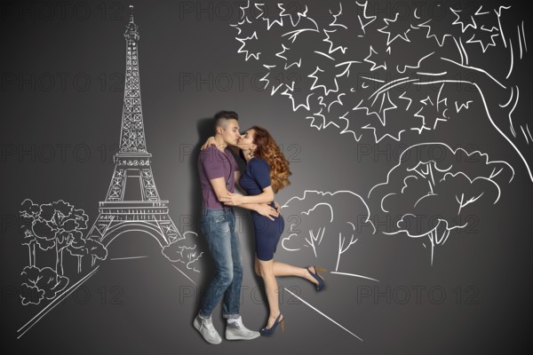 Happy valentines love story concept of a romantic couple in Paris kissing under the Eiffel Tower against chalk drawings background
