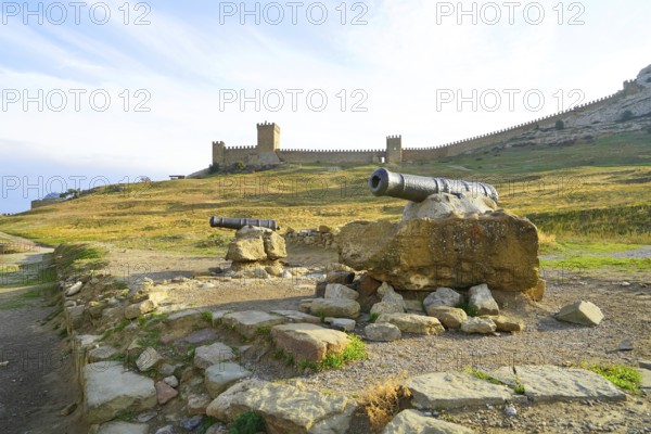 Autumn morning and mountain landscape by the sea, old fortress on the rocks above the sea