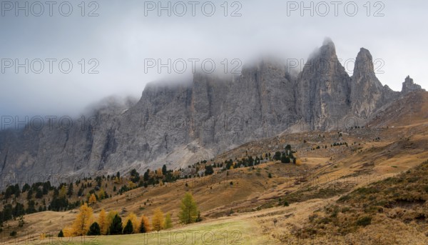 Mountain landscape of dolomites covered with fog Italian alps in autumn. Nature scenery Italy. Passo Sella South tyrol