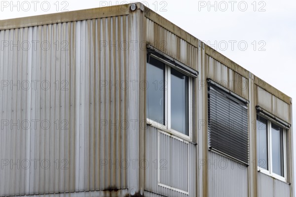 Corner view of an industrial building with a metal exterior and several windows