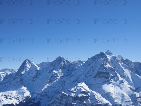 View from the peak of Schilthorn in the skiing resort of Muerren, Switzerland, on a beautiful winter day. Panorama of the famous mountains, Eiger, Moench, and Jungfrau, Europe