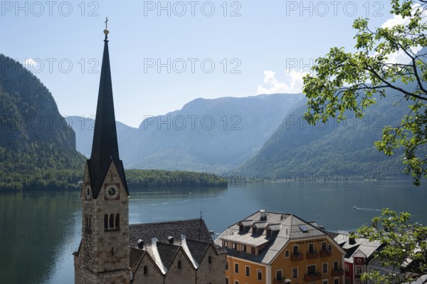 18.06.2019, Hallstatt, Upper Austria, Austria, Europe, View of the small village with church, Lake Hallstatt and mountains in the background. The village is a favourite travel destination for the Chinese and exists as a replica in the Chinese province of Guangdong, Europe