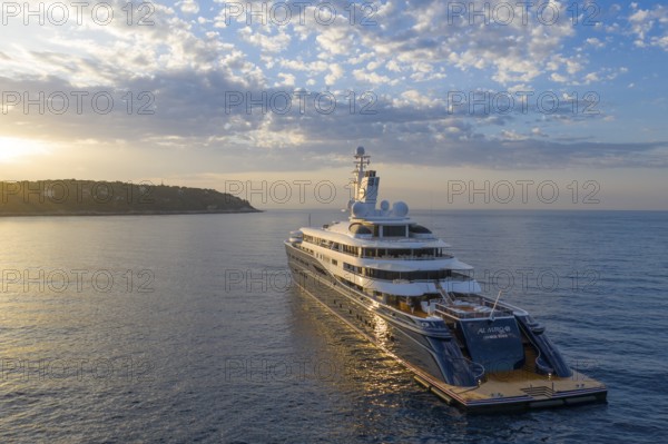 Aerial view of 133 metre motor yacht AL MIRQAB, delivered in 2008 by the German shipyard Kusch Yachts, Peters Schiffbau to Sheikh Hamad bin Jassim bin Jaber bin Muhammad Al Thani, member of the royal family of Qatar, designer Tim Heywood, early in the morning shortly after sunrise at anchor off the Principality of Monaco, Cote d'Azur, Mediterranean Sea