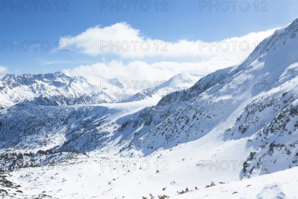 Tops of Pirin mountains view from top of cable car, ski resort Bansko, Bulgaria.