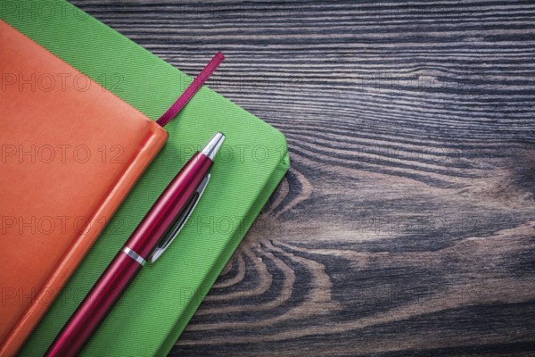 Diary books brio pen on wooden board education concept