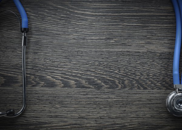 Stethoscope on vintage wooden board medicine concept