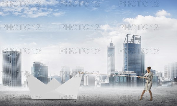 Successful businesswoman pulling with rope paper boat
