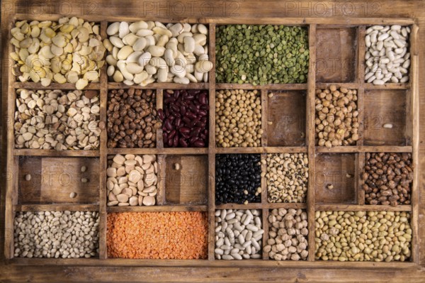 Presentation in an old wooden container varieties of dried legumes