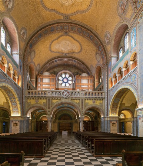 Szeged, Hungary, 14 October, 2022: view of the central nave with wooden pews and the church organ inside the Szeged Cathedral, Europe