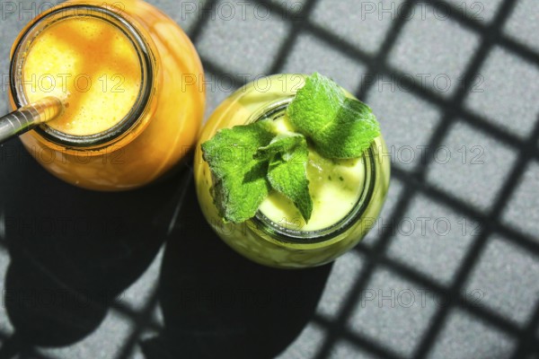 Seasonal Matcha green vegan smoothie with chia seeds and mint pumpkin carrot smoothie drink detox Breakfast. Clean eating, weight loss, healthy dieting food concept Fruit vegetable drink fitness. Trendy shadows
