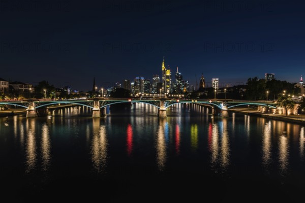 Frankfurt am Main, Hesse, Germany, 07 23 2018: cityscape at night taken from the river Main at the Flosserbrucke, Europe