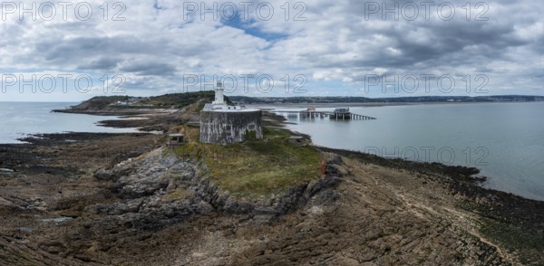 Aerial view of the Mumbles headland with the historic lighthouse and piers in Swansea Bay