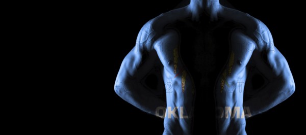 Oklahoma flag on muscled male torso with abs, Oklahoma bodybuilding concept, black background