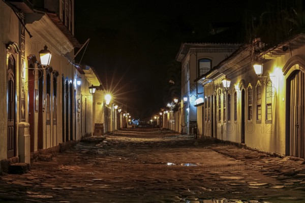 Atmospheric night view of illuminated street and buildings in historical center of Paraty, Brazil, Unesco World Heritage, South America