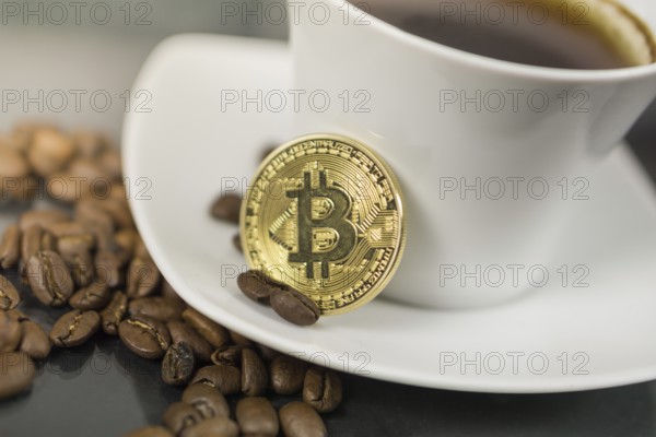 Photo of Bitcoin cryptocurrency coin with coffee cup and coffee beans