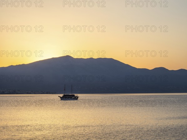 Ship in the morning light in front of sunrise, Peljesac peninsula, view from Korcula, Dalmatia, Croatia, Europe