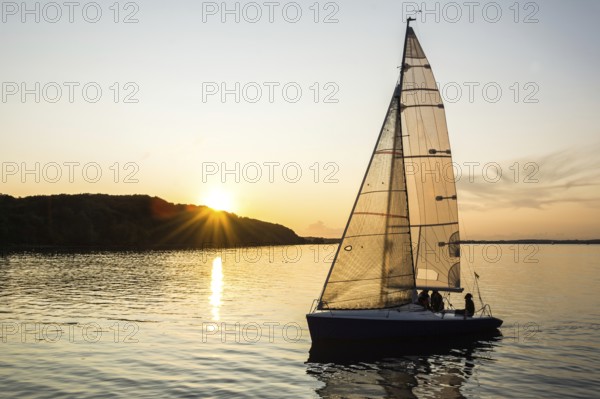 Sailing boat sailing into the harbor during beautiful sunset