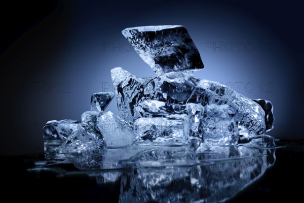 Frozen block of ice with blue tinted background