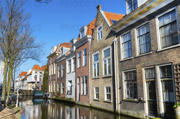 Colorful street view with traditional dutch houses, canal in downtown of popular Holland destination