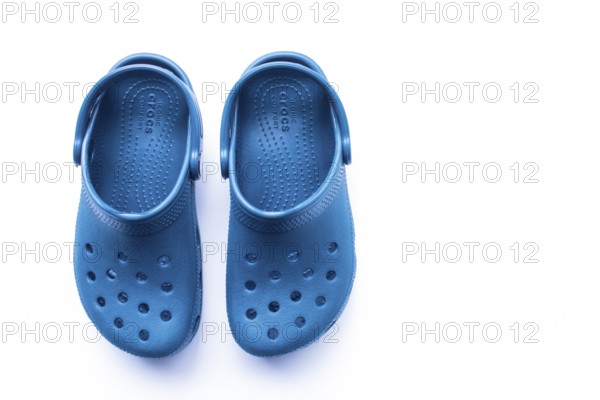 Calgary, Alberta, Canada. Nov. 19, 2020. Top View of Blue Crocs footwear, foam clog shoes on a white background