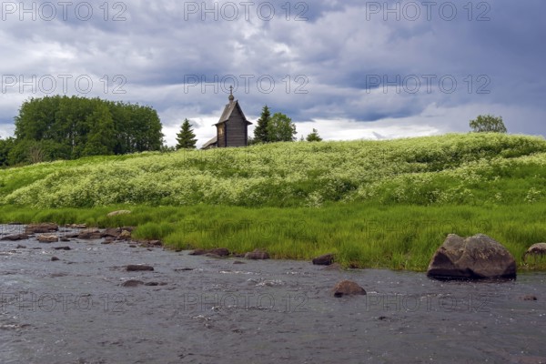 Wooden chapel on the banks of the river Keret. At this point the Keret River flows into the White Sea. Karelia, Russia, end of June, Europe