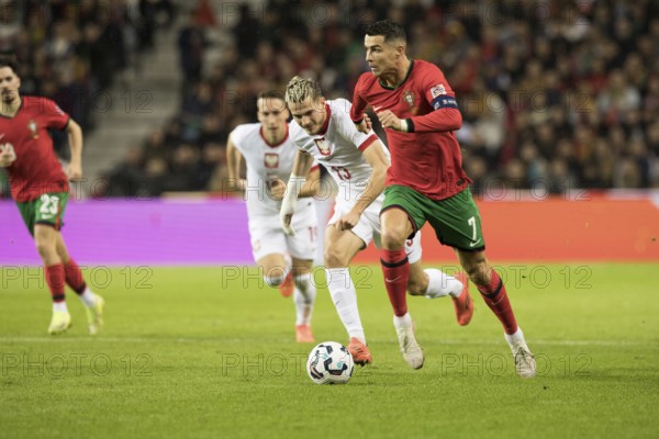 Football match, captain Cristiano RONALDO CR7 Portugal right on the ball runs towards the opponent's penalty area with a concentrated look ahead, Jakub KAMINSKI 13 Poland and Dominik MARCZUK 19 Poland follow him, on the left outside VITINHA Portugal can be seen slightly obscured, sequence 3, Estadio do Dragao, Porto, Portugal, Europe