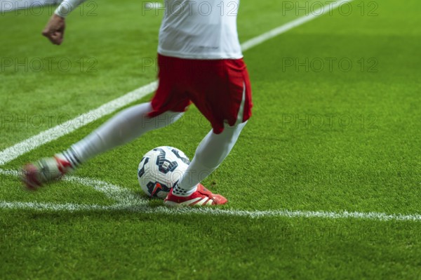 WARSAW, POLAND - MARCH 21, 2025: Qualifications for FIFA World Championship 2026. Match Poland - Lithuania. Footballer takes the corner. Detail of player's legs and the ball