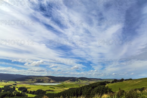 Caitlins Scenic Road. Incredible sky and clouds of summer sunset. South Island. The southernmost point of New Zealand. The concept of active, environmental and photo tourism