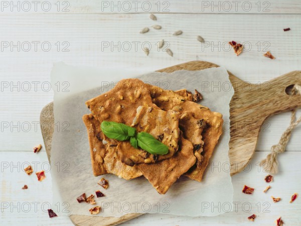 Gluten-freen crispbreads made of buskwheat flour. Green buckwheat flour smoked paprika sunflower seeds ingredients homemade baked crisp bread. Idea recipe snacks gluten free concept. Top view flat lay
