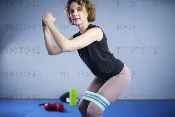 Legs woman barefoot doing pilates exercise with elastic fabric resistance band. Resistance Bands for butt and Legs, Exercise bands working out, stretching, physical therapy. Elastic bands for fitness