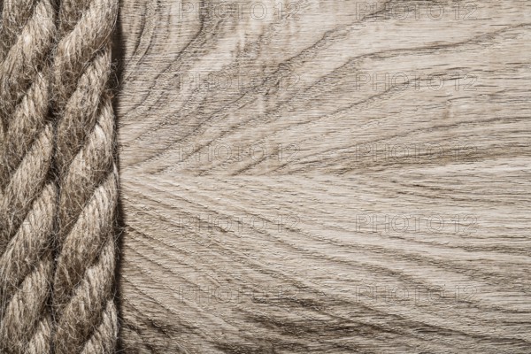 Vintage twisted jute cables on wooden board copy space
