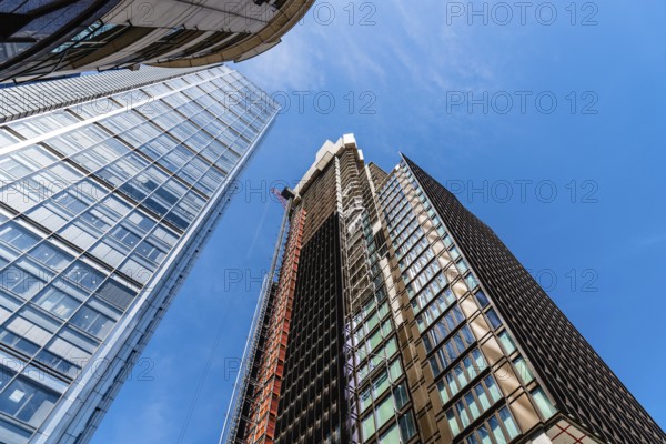 London, UK, May 14, 2019: Low angle view of office buildings under construction in the City of London against blue sky