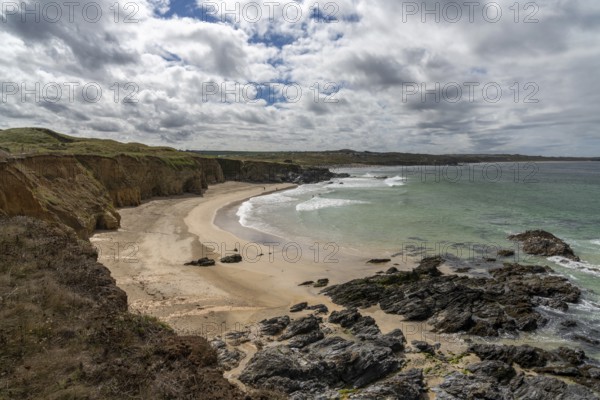 A view of the beautiful golden sand beach at Gwithian with tropical turquoise ocean water and a view of the Cornwall Coast