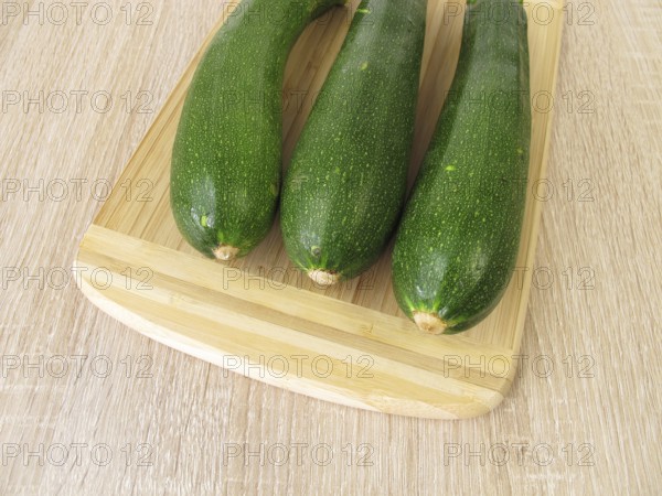 Green courgettes on a chopping board