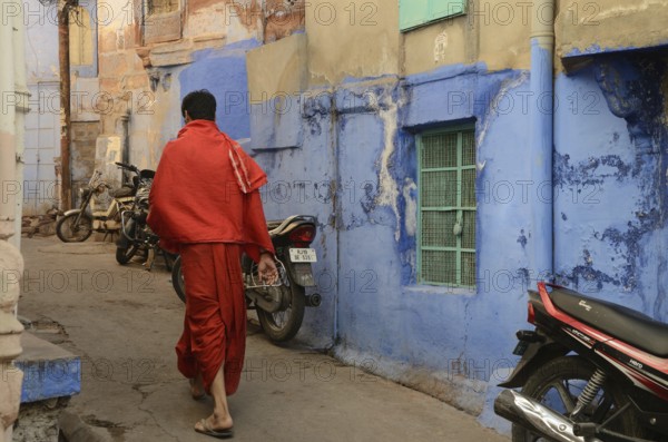 Priest walking in narrow lane, jodhpur, rajasthan, India, Asia, NOMR, Asia