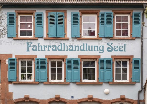 Old house with turquoise shutters and the inscription Fahrradhandlung Seel in the old town centre of Annweiler am Trifels, Rhineland-Palatinate, Germany, Europe
