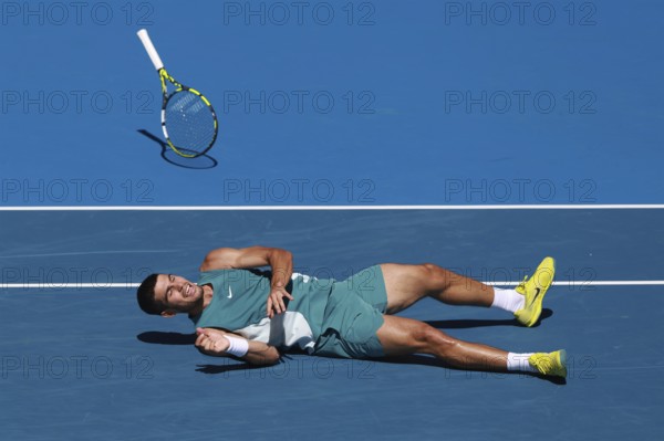 Spanish tennis player Carlos Alcaraz (ESP) diving for forehand shot and falling to the ground at the Australian Open 2025 tournament, Melbourne Park, Melbourne, Victoria, Australia, Oceania