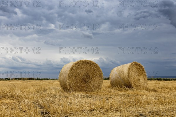 Straw bales on farmland Storm clouds