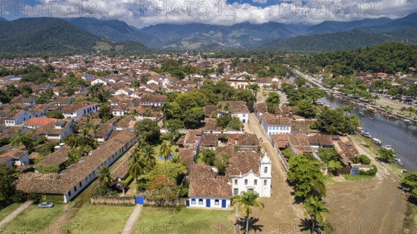 Aerial view to historic town Paraty with tidal river and green mountains in background on a sunny day, Brazil, Unesco World Heritage, South America