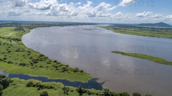Aerial view Magdalena River and green rural landscape with blue sky and white clouds in Colombia