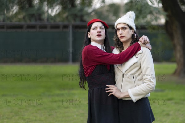 Couple of transgender women posing sensually in a park